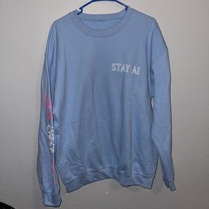 Light blue sweatshirt with decals